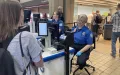A traveler waits while the tablet captures her photo to immediately verify that her face matches the face on her ID. (TSA photo)
