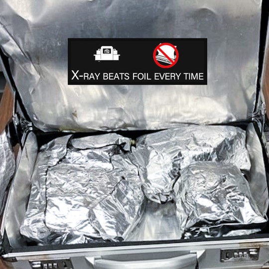X-ray beats foil every time. Briefcase with items hidden/wrapped in aluminum foil. 