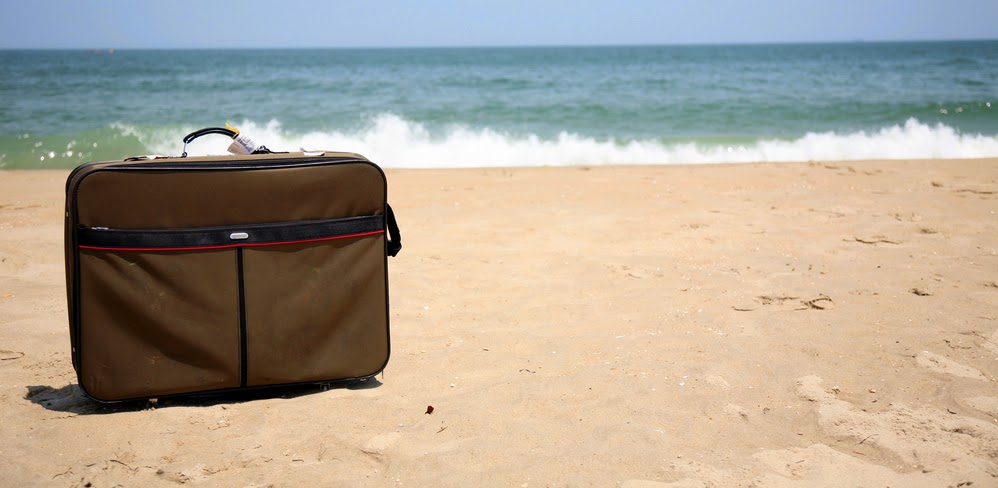 on the beach hand luggage