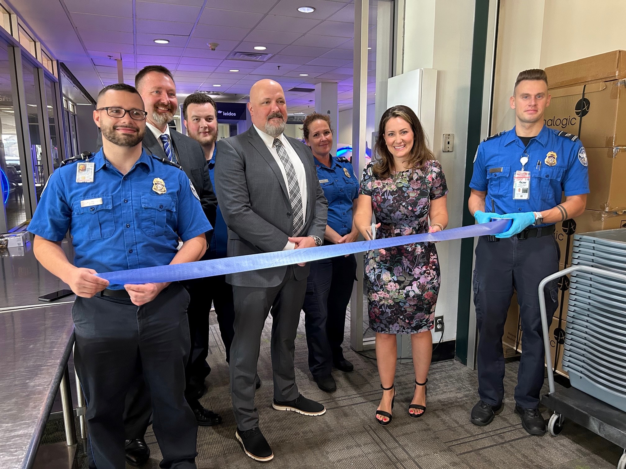 TSA and airport officials cut a ribbon as the new computed tomography (CT) checkpoint scanners are introduced at West Virginia International Yeager Airport. (TSA photo)