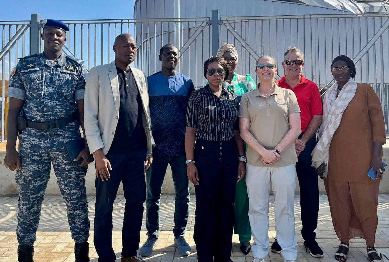 Cybersecurity Compliance and Enforcement Division Branch Manager B.J. Johnson (front center in black), TSAR Lori Silcox (third from right in khaki) and TSA Industry Engagement Manager Chris McKay (second from right in red) with Senegal transportation officials. (Photo by Lori Silcox)