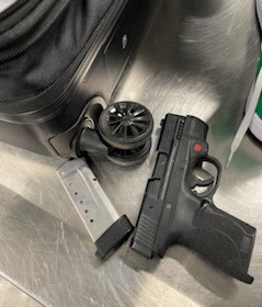 This gun and loaded magazine were removed from a pair of sneakers packed in a checked bag at LaGuardia Airport on Nov. 1. (TSA photo)