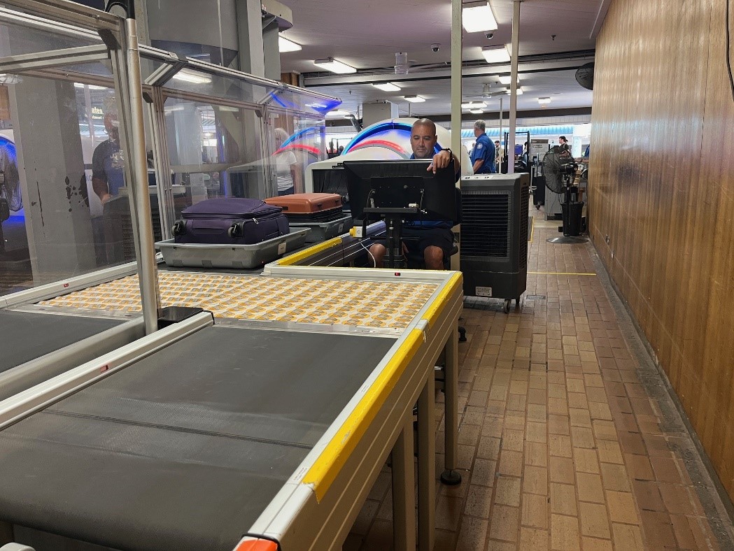 A TSA officer at LIH uses computed tomography X-ray technology to screen departing travelers’ carry-on property in the security checkpoint.