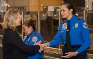 Los Angeles International Airport Lead TSA Officer Rhonda Vea (right) greets Domestic Aviation Operations Assistant Administrator Michal Rottman. (Photo by Stephanie Santamaria and Charles King)