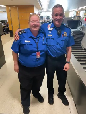 Seattle-Tacoma International Airport (SEA) Supervisory TSA Officers Teri Shoemaker and John Rhoades come to the aid of a passenger who suddenly collapsed near the checkpoint. (Photo courtesy of TSA SEA)