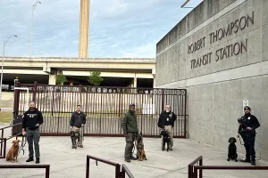 Front of Robert Thompson Transit Station with five agents and five dogs