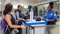 JFK TSA Officer Brittany Brooks checking passenger documents. (Photo by JFK Crown Communications team)