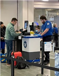 A passenger scans his electronic boarding pass at a security checkpoint. (TSA photo)