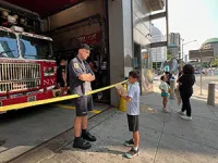 Benjamin stops to chat with a New York firefighter. 