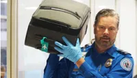 IAH TSA Officer Curtis Archer processing luggage at the checkpoint.  (Image by IAH Media Team)