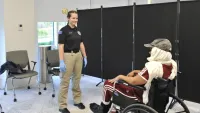 A TSA Olympian prepares to pat-down a passenger in a wheelchair. (Roderica Clohessy photo)