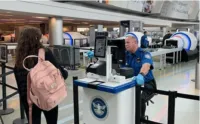 A traveler waits while the tablet captures her photo to immediately verify that her face matches the face on her ID. (TSA photo)