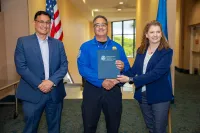 PBI Officer Lito Marrero received    PBI Good Catch Award from FSD Pete Garcia and Enterprise Support Executive Assistant Administrator Julie Scanlon. (Mauricio Santamaria photo)