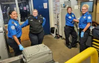 STI Heidi Payton in the SBN checked baggage area with TSA Officers Terri Fennessee, Tina Ball, Lorie Appleberry. (Malik Johnson photo)