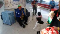 TSA Officer Doug Heltibridle plays his saxophone during the holiday celebration at IAD. (Stan Pardos)