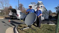 RIC Supervisory TSA Officer Brian Bostian and TSA Manager Paul Hammarbeck with the Hughes satellite system. (TSA photo)