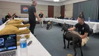 Canine medic Chris Stone instructs handlers April Dwight and Michael Rossi on canine hold techniques. (TSA TPA photo)