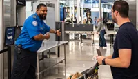 ORD STSO John Morgan assisting a passenger. (Photo by Illinois Media Team)