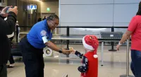 Happy customer gets a badge from a festive TSA officer at PHX. (TSA PHX)