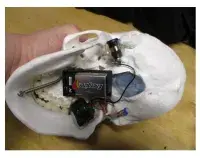 The underside of the suspicious skull with wires, 9-volt battery and an unknown substance taped in the cranium. (Photo courtesy of TSA SLC)