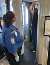 Supervisory TSA Officer Melanie Duran at the PUB advanced imaging technology screening machine. (Alan Johnson photo)