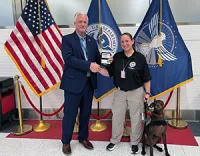 DCA Federal Security Director John Busch gives Katie Antonovich and Niki their credentials.