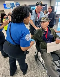 Richmond International Airport TSA Officer Valerie Jackson greets a Soaring Valor participant. (Cynthia Scott)