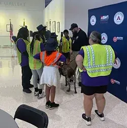 These Baltimore students meet TSA canine Medo and his handler Patrick McGonagle at BWI. (TSA BWI photo) 