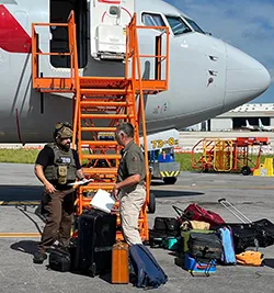 TSA explosives expert Scott Dickson (right) briefs a Miami-Dade Bomb Squad officer during an IED training exercise. (Photo courtesy of TSA MIA)
