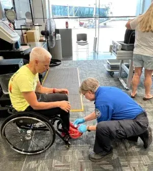 As this Para-Cycling World Cup participant prepares to fly home, Huntsville International Airport (HSV) Lead TSA Officer Theresa Musso provides the proper security screening at the HSV TSA checkpoint. (Photo courtesy of TSA HSV)