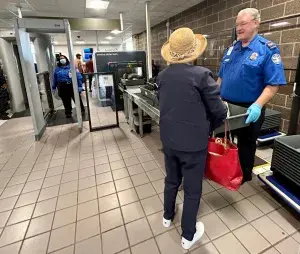 A traveler prepares to put her items onto the conveyor belt to enter the new computed tomography scanner at the Salisbury-Ocean City Wicomico Regional Airport checkpoint. (TSA photo)