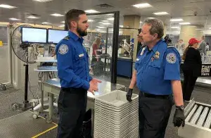 Supervisory Officer Zachary Fate discusses TSA security operations with a fellow supervisor at Phoenix Sky Harbor International Airport. (Photo by Patricia Mancha)