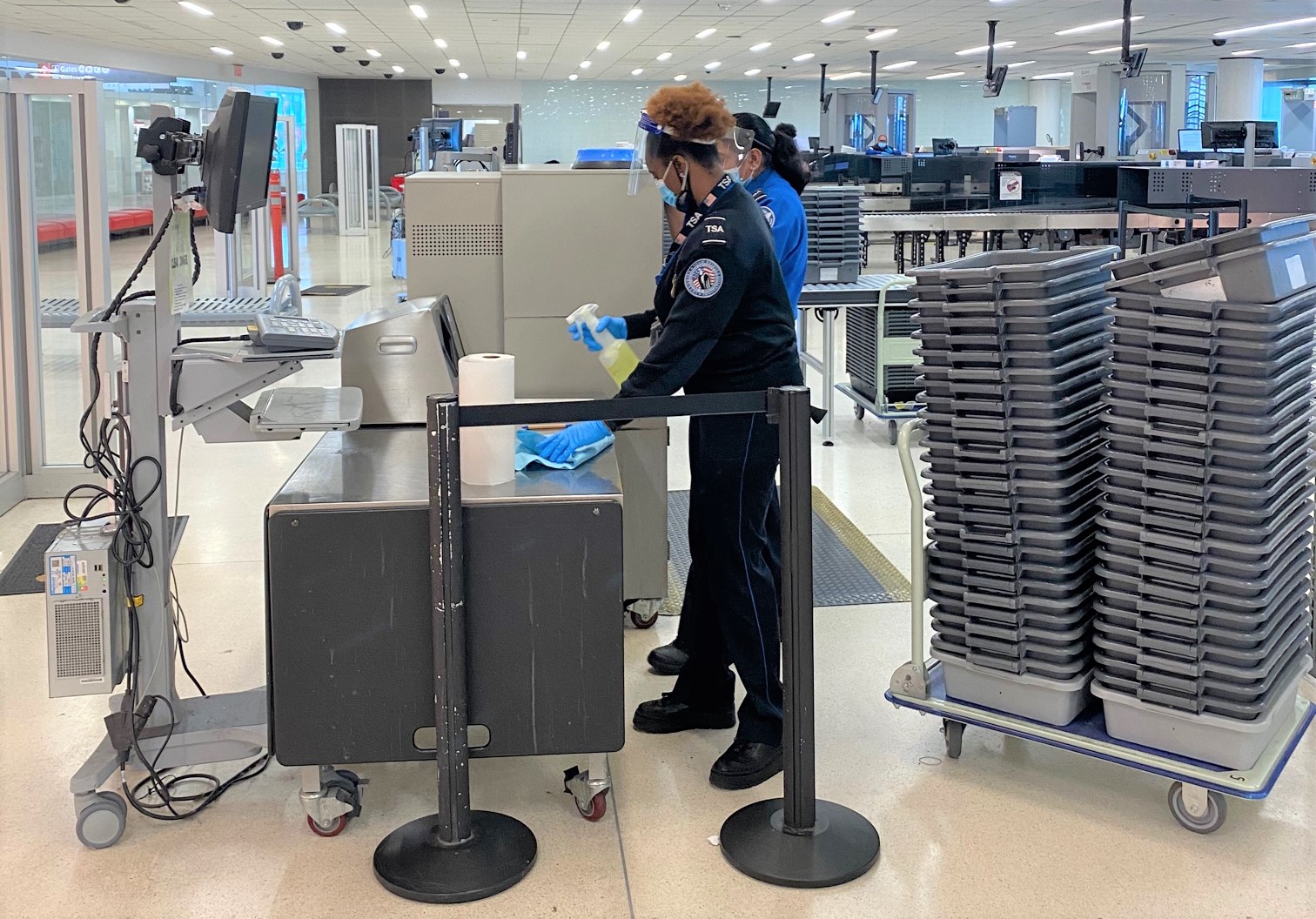 TSA officers at Philadelphia International Airport disinfecting surfaces at a security checkpoint. (TSA photo)